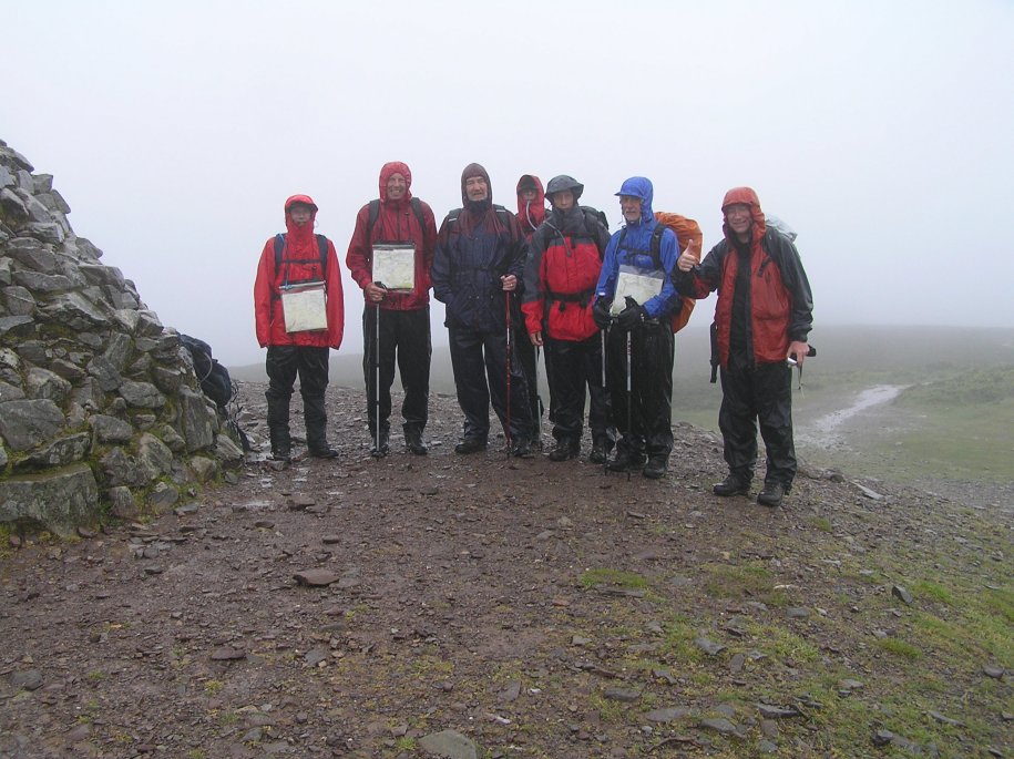 Eight (inc Andy taking the pic) very wet & bedragled walkers on top of Dunkery beacon.